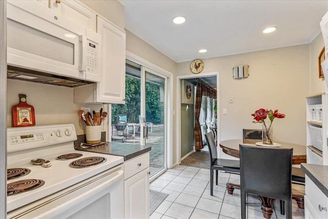 49 Radcliff Ave, Port Washington, NY 11050 - kitchen featuring white appliances, white cabinetry, light tile patterned flooring, dark countertops, and recessed lighting