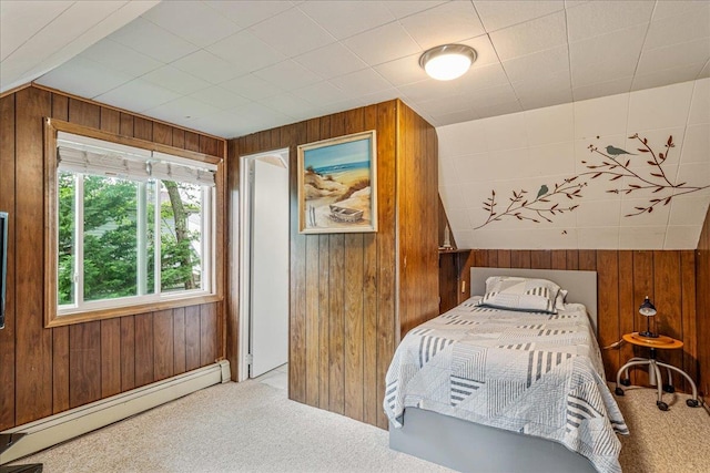 49 Radcliff Ave, Port Washington, NY 11050 - bedroom with wooden walls, baseboard heating, and carpet flooring