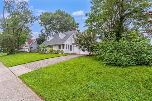 49 Radcliff Ave, Port Washington, NY 11050 - cape cod-style house with a front lawn, a chimney, and a garage