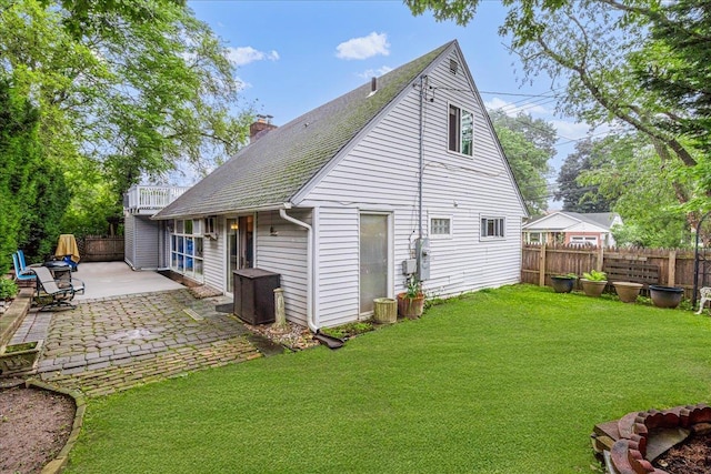 49 Radcliff Ave, Port Washington, NY 11050 - rear view of property featuring a patio area, a chimney, a shingled roof, and a balcony