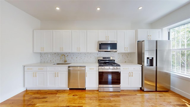 442 Newport St, Brooklyn, NY 11207 - kitchen with appliances with stainless steel finishes, decorative backsplash, light countertops, white cabinets, and recessed lighting