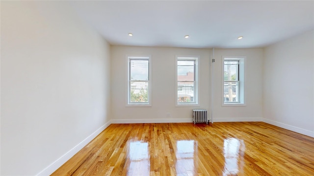 442 Newport St, Brooklyn, NY 11207 - unfurnished room with radiator heating unit, light wood-style flooring, and recessed lighting