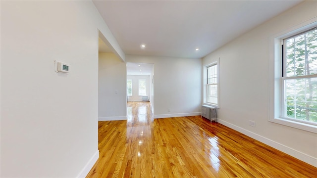 442 Newport St, Brooklyn, NY 11207 - spare room with radiator heating unit, light wood-style flooring, and recessed lighting