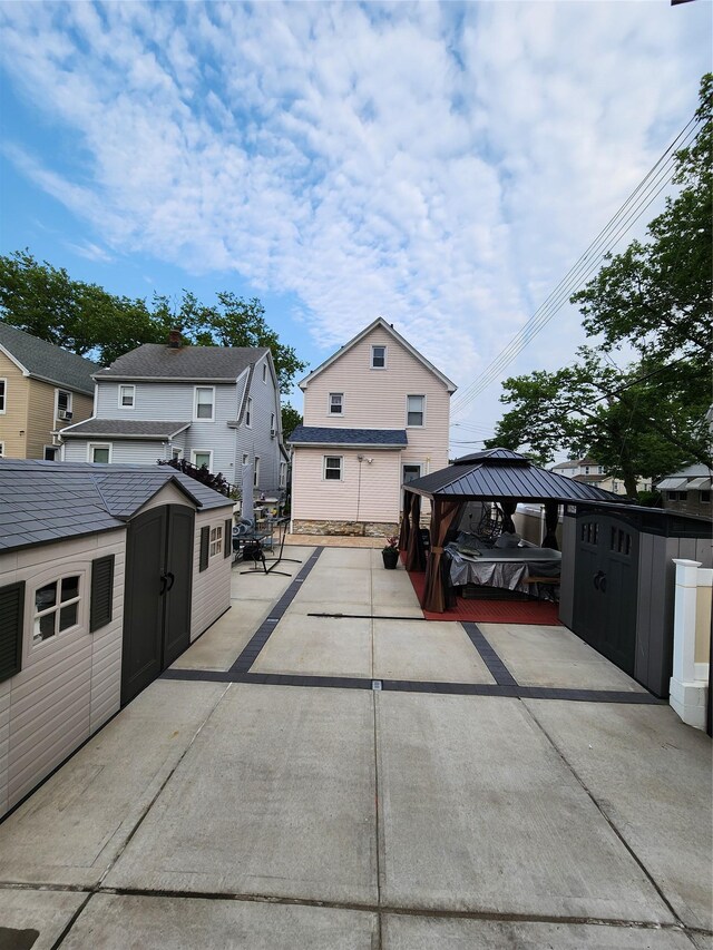 18701 Keeseville Ave, Saint Albans, NY 11412 - rear view of house with a shed, a patio, and a gazebo