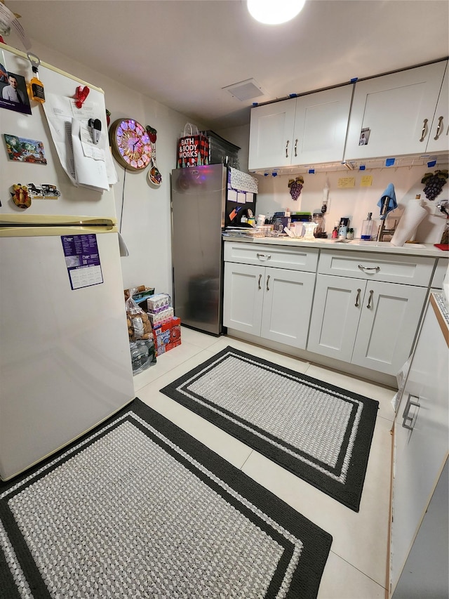 18701 Keeseville Ave, Saint Albans, NY 11412 - kitchen featuring white cabinetry, freestanding refrigerator, and light countertops