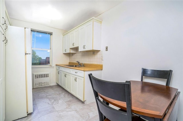 4380 Vireo Ave Unit 5D, Bronx, NY 10470 - kitchen featuring freestanding refrigerator, radiator, tasteful backsplash, white cabinetry, and light countertops