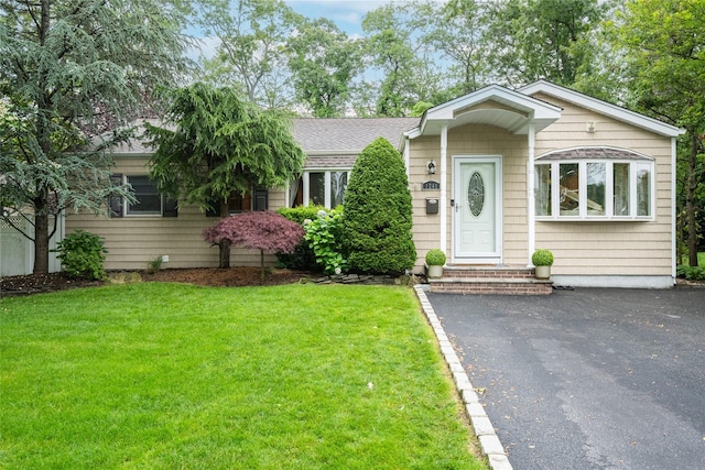 1241 Lednam Ct, Merrick, NY 11566 - view of front of property with a front yard and a shingled roof