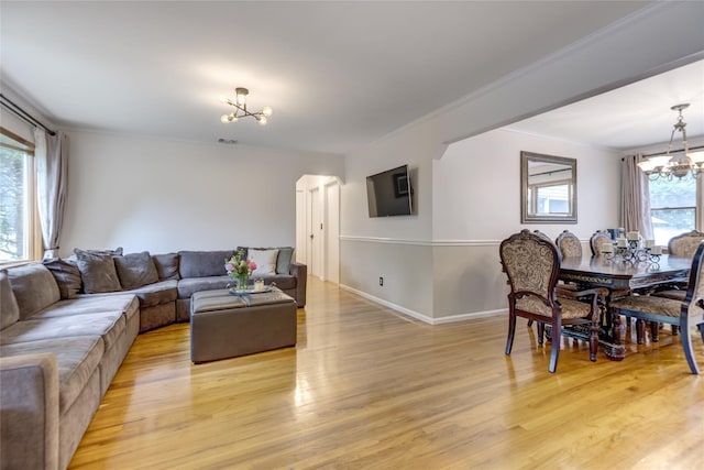 1241 Lednam Ct, Merrick, NY 11566 - living room with a chandelier, ornamental molding, and light wood finished floors
