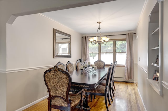 1241 Lednam Ct, Merrick, NY 11566 - dining room with light wood-style floors, a chandelier, crown molding, and baseboard heating