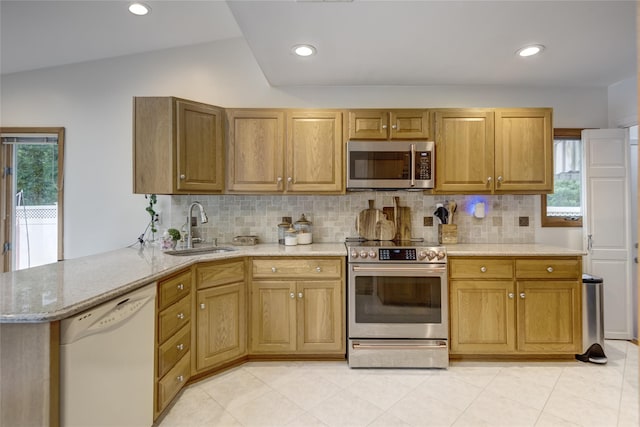 1241 Lednam Ct, Merrick, NY 11566 - kitchen with appliances with stainless steel finishes, plenty of natural light, decorative backsplash, lofted ceiling, and recessed lighting