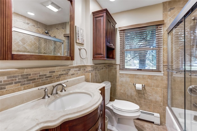 1241 Lednam Ct, Merrick, NY 11566 - bathroom with a baseboard heating unit, tile walls, vanity, and enclosed tub / shower combo
