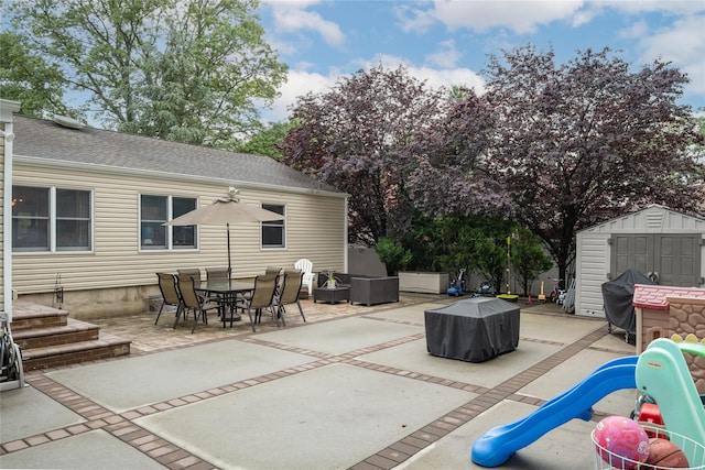 1241 Lednam Ct, Merrick, NY 11566 - view of patio with a storage shed, a fire pit, a grill, and outdoor dining space