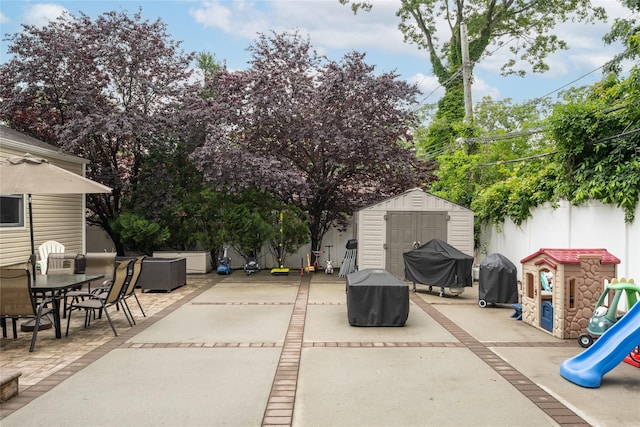 1241 Lednam Ct, Merrick, NY 11566 - view of patio / terrace featuring a storage shed, outdoor dining area, and a playground