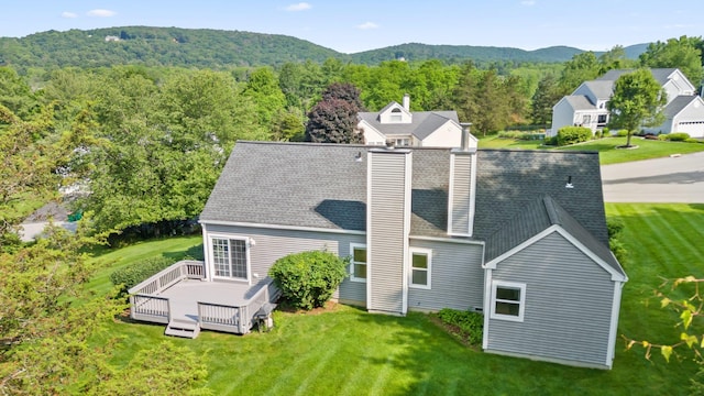 29 Underhill Rd N, Poughquag, NY 12570 - back of property featuring a wooded view, a chimney, a wooden deck, and a yard
