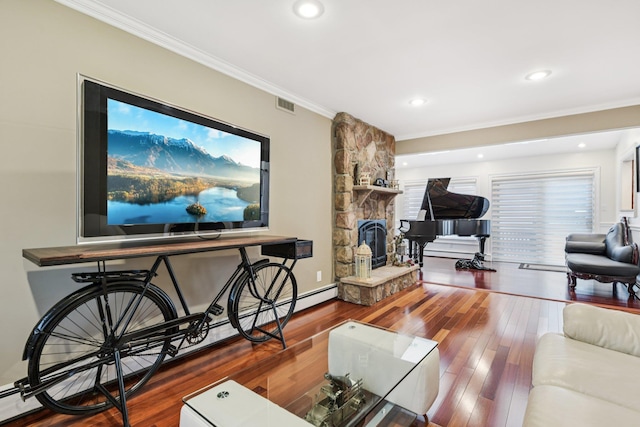 57 Sarah Dr, Lake Grove, NY 11755 - living area featuring crown molding, a stone fireplace, hardwood / wood-style floors, baseboard heating, and recessed lighting