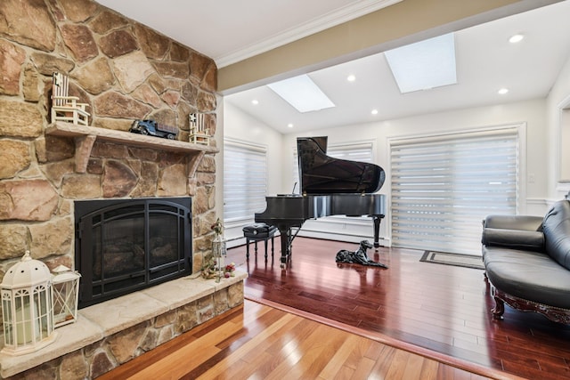 57 Sarah Dr, Lake Grove, NY 11755 - living area with a skylight, hardwood / wood-style flooring, a fireplace, crown molding, and lofted ceiling