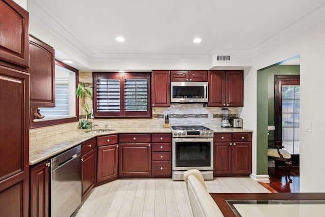 57 Sarah Dr, Lake Grove, NY 11755 - kitchen featuring stainless steel appliances, dark brown cabinets, light wood finished floors, backsplash, and light stone counters