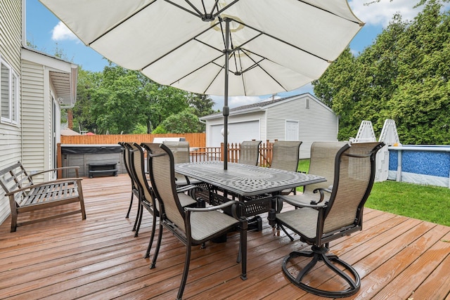 57 Sarah Dr, Lake Grove, NY 11755 - wooden terrace featuring outdoor dining space, a hot tub, an outdoor pool, an outdoor structure, and a detached garage