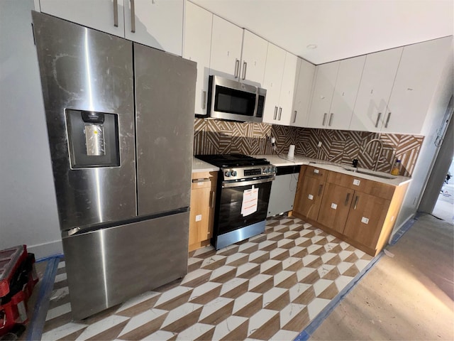 982 E 106th St, Brooklyn, NY 11236 - kitchen featuring stainless steel appliances, decorative backsplash, light countertops, and white cabinetry