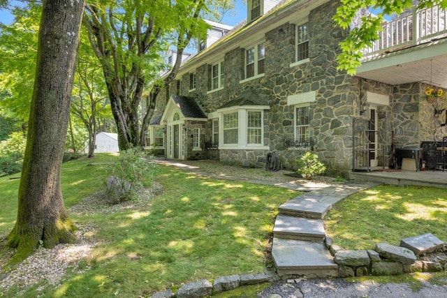 23 Gracemere, Tarrytown, NY 10591 - view of front facade with stone siding, a front yard, and a chimney