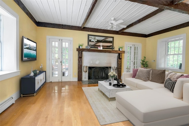 23 Gracemere, Tarrytown, NY 10591 - living room with a baseboard heating unit, french doors, healthy amount of natural light, light wood-style floors, and a wooden ceiling with exposed beams