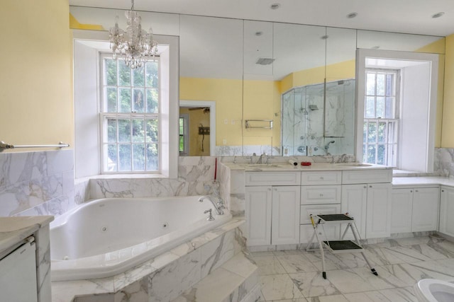 23 Gracemere, Tarrytown, NY 10591 - bathroom with double vanity, healthy amount of natural light, a jetted tub, and a chandelier