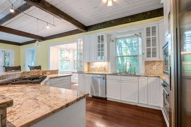 23 Gracemere, Tarrytown, NY 10591 - kitchen featuring appliances with stainless steel finishes, beamed ceiling, dark wood-type flooring, white cabinets, and backsplash