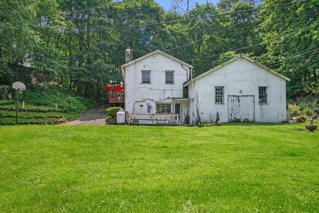 23 Gracemere, Tarrytown, NY 10591 - back of property featuring a yard, a chimney, a wooden deck, and stucco siding