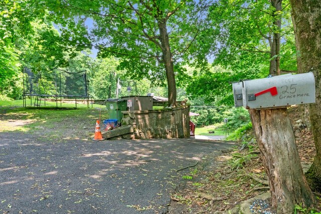 23 Gracemere, Tarrytown, NY 10591 - view of jungle gym featuring a trampoline and view of wooded area