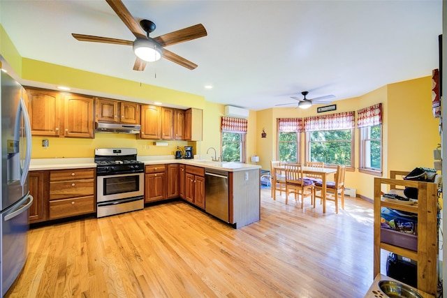 322 Union School Rd, Middletown, NY 10941 - kitchen featuring appliances with stainless steel finishes, a ceiling fan, a peninsula, under cabinet range hood, and brown cabinets