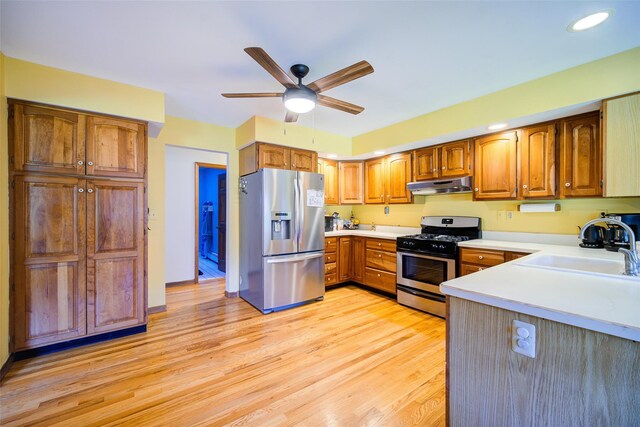 322 Union School Rd, Middletown, NY 10941 - kitchen with appliances with stainless steel finishes, under cabinet range hood, light wood-style flooring, a ceiling fan, and light countertops