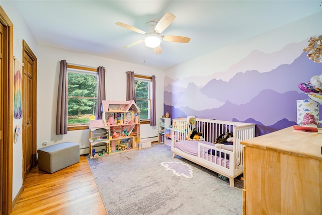 322 Union School Rd, Middletown, NY 10941 - bedroom with wood finished floors, a baseboard radiator, and a ceiling fan