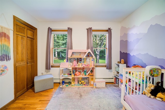 322 Union School Rd, Middletown, NY 10941 - game room featuring wood finished floors and a baseboard heating unit