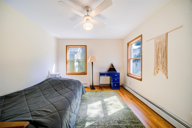 322 Union School Rd, Middletown, NY 10941 - bedroom featuring a baseboard radiator, multiple windows, and wood finished floors
