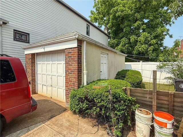 3820 Clarendon Rd, Brooklyn, NY 11203 - view of side of home featuring a garage, brick siding, and driveway