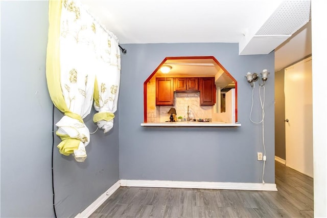 3820 Clarendon Rd, Brooklyn, NY 11203 - kitchen with wood finished floors, tasteful backsplash, arched walkways, and light countertops