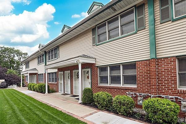 183 Atlantic Ave Unit 8, Lynbrook, NY 11563 - multi unit property featuring brick siding and a front lawn