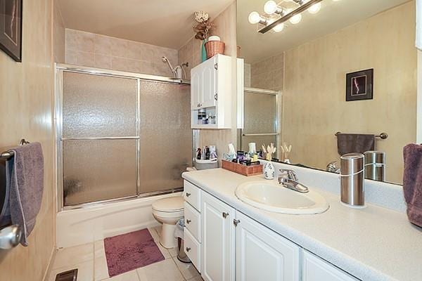 183 Atlantic Ave Unit 8, Lynbrook, NY 11563 - bathroom with vanity, tile patterned flooring, and bath / shower combo with glass door