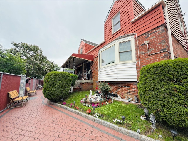 945 Swinton Ave, Bronx, NY 10465 - view of side of home with a patio area and brick siding