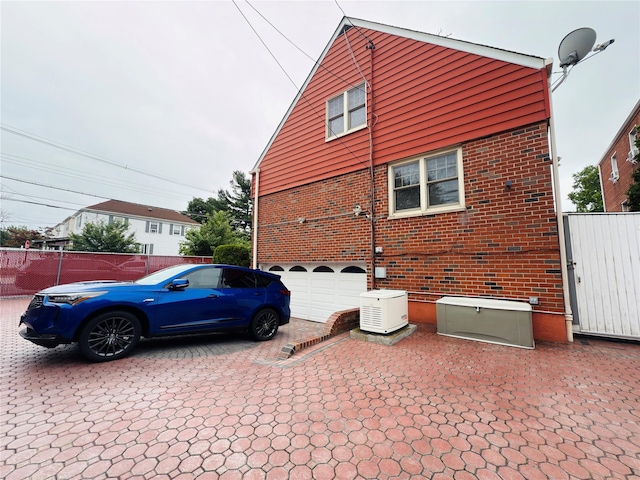 945 Swinton Ave, Bronx, NY 10465 - view of property exterior with brick siding and an attached garage