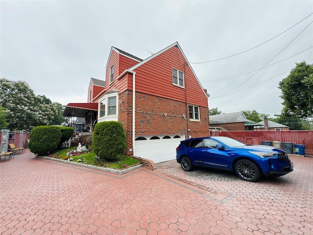 945 Swinton Ave, Bronx, NY 10465 - view of side of home featuring brick siding, a garage, and driveway