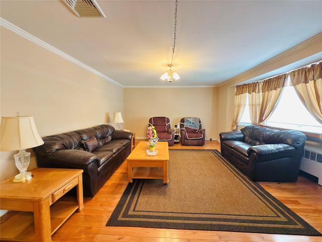 945 Swinton Ave, Bronx, NY 10465 - living room with radiator, light wood-type flooring, crown molding, and a chandelier