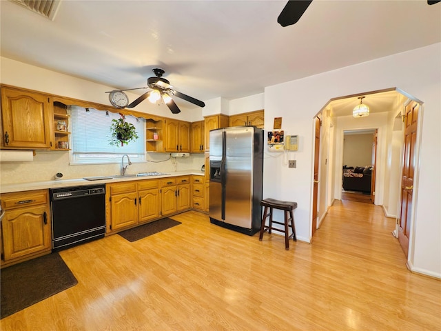 945 Swinton Ave, Bronx, NY 10465 - kitchen featuring stainless steel fridge, black dishwasher, a ceiling fan, open shelves, and brown cabinetry
