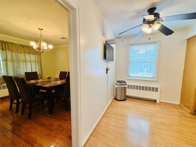 945 Swinton Ave, Bronx, NY 10465 - dining space with radiator heating unit, a chandelier, light wood-style floors, ceiling fan, and crown molding