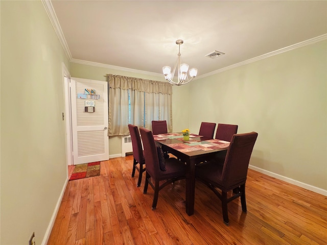 945 Swinton Ave, Bronx, NY 10465 - dining area featuring radiator heating unit, a chandelier, crown molding, and light wood-style floors