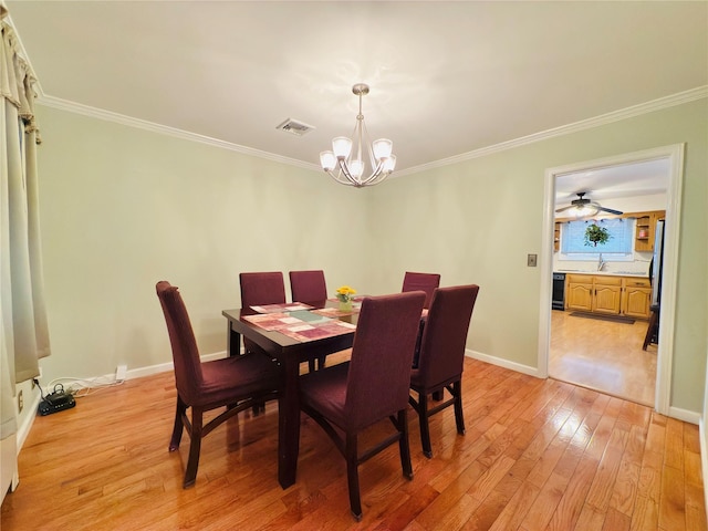 945 Swinton Ave, Bronx, NY 10465 - dining space featuring a chandelier, crown molding, and light wood-style flooring