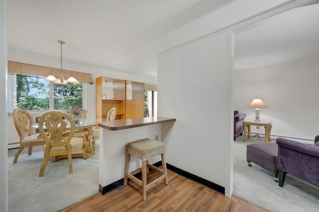 12 Scenic Dr Unit K, Croton-On-Hudson, NY 10520 - kitchen featuring a chandelier, wood finished floors, hanging light fixtures, and a baseboard heating unit