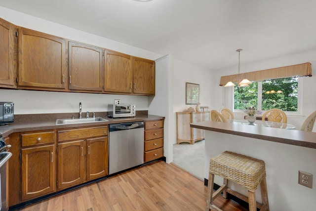12 Scenic Dr Unit K, Croton-On-Hudson, NY 10520 - kitchen featuring stainless steel dishwasher, light wood-type flooring, dark countertops, and brown cabinetry