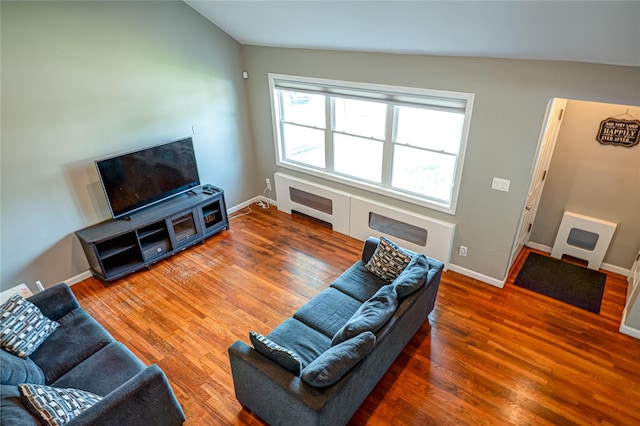 17 Abbott St, West Babylon, NY 11704 - living area featuring wood finished floors, heating unit, and vaulted ceiling