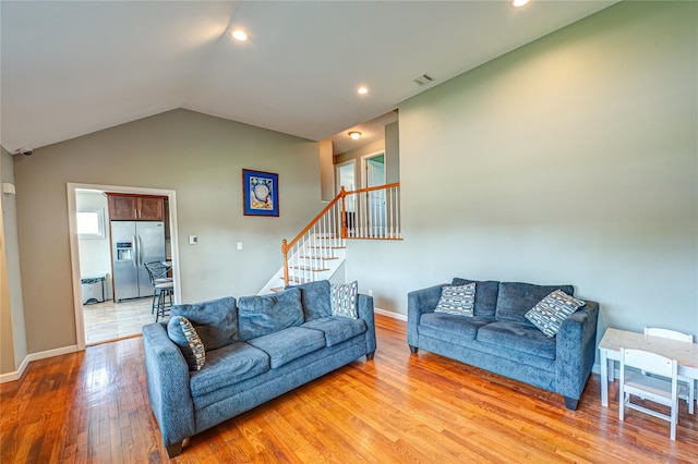 17 Abbott St, West Babylon, NY 11704 - living area featuring light wood finished floors, vaulted ceiling, stairway, and recessed lighting